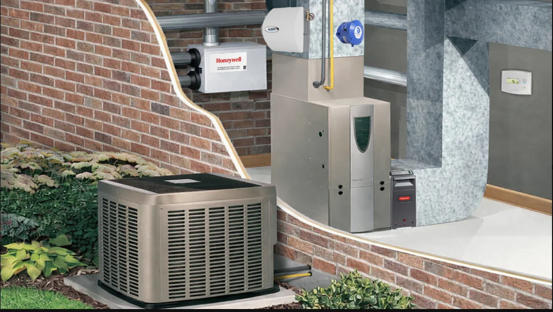 A Freeman Infinity Air technician inspecting an HVAC air handler unit inside a Greenville, SC home during an indoor air quality assessment. The technician reviews ductwork connections and filtration components in a residential utility room.